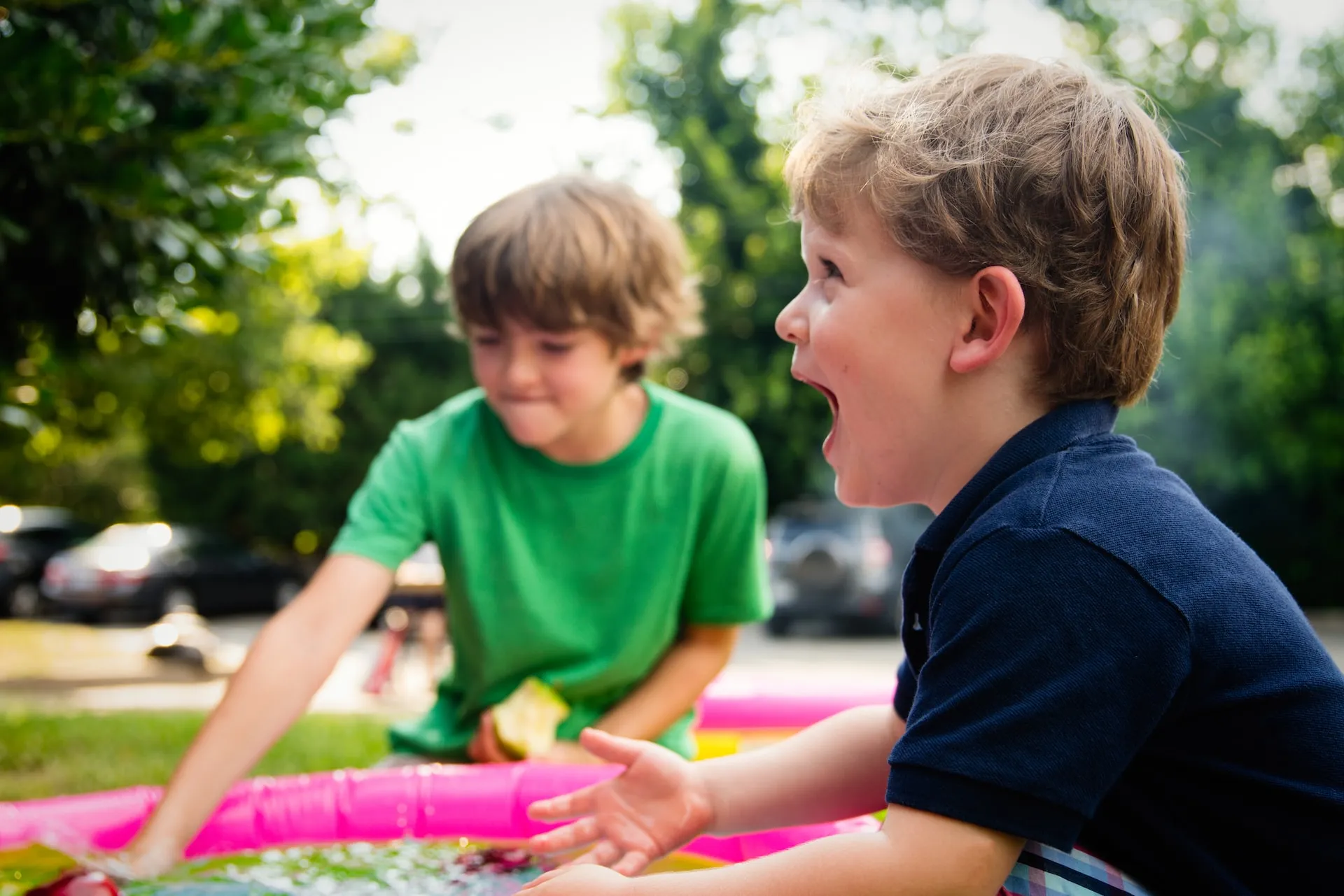 Happy kids playing with water outdoors